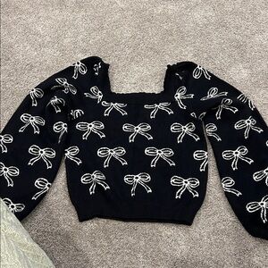 Willow and Wind size large black sweater with a bow pattern